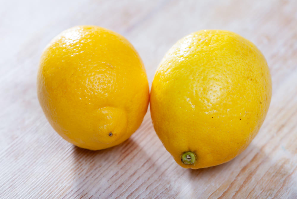 Whole lemon on wooden table