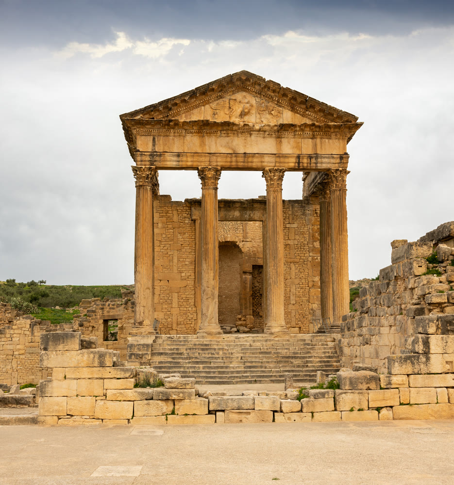 Remains of Capitol Temple of Dougga in Tunisia under cloudy sky