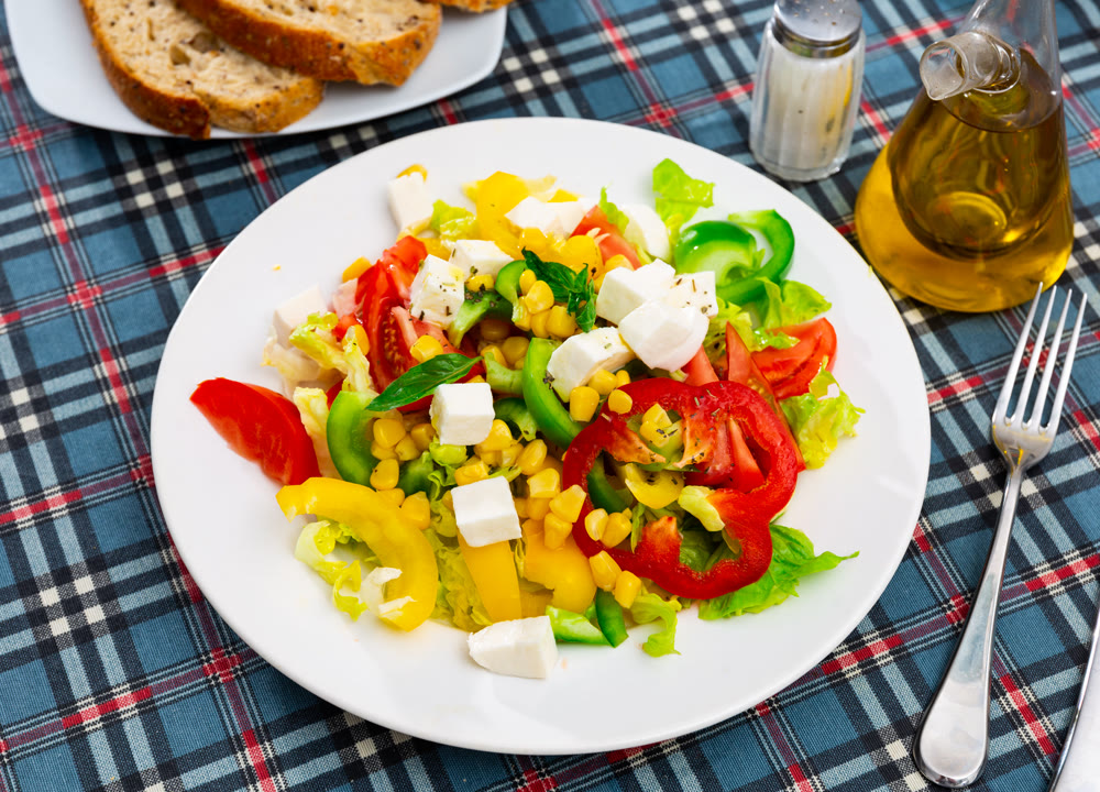 Salad with cheese, tomato, peppers, and corn