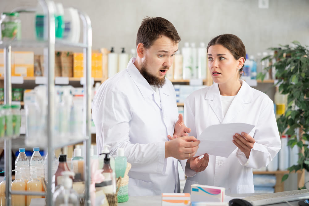 Two pharmacists annoyed near the computer