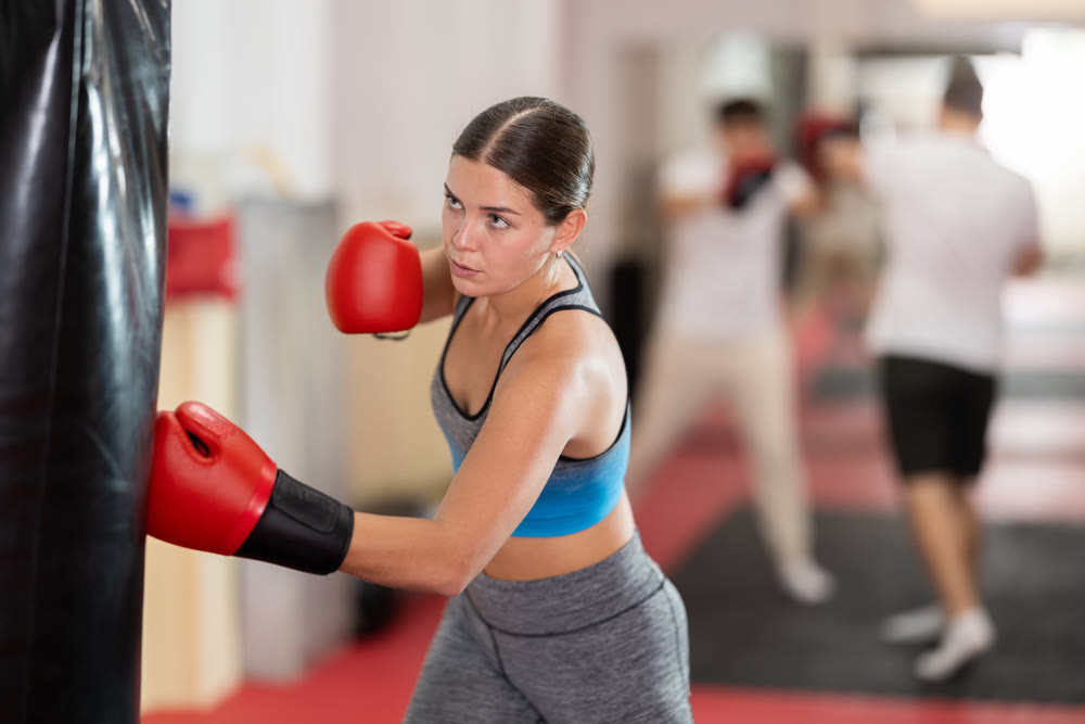 Woman training in boxing section