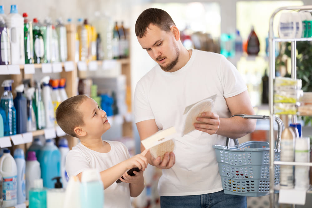 Schoolboy son and dad are choosing bast wisp in store