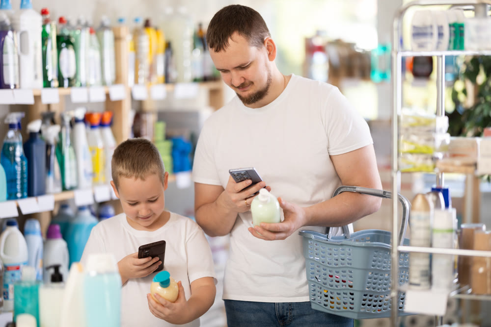 Man and boy scanning qr code for liquid soap
