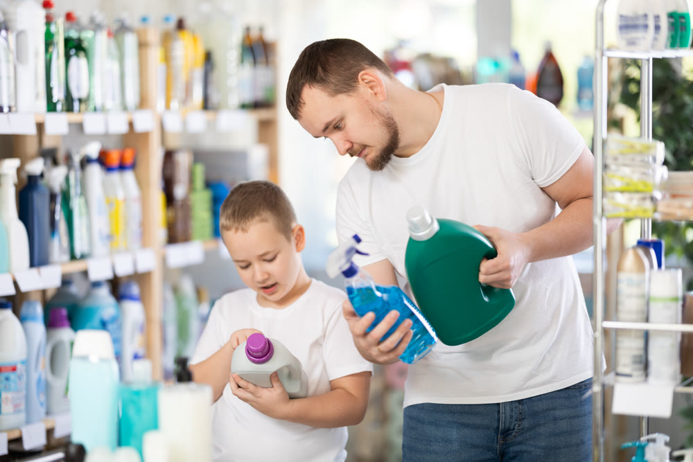 Young man and boy choosing detergent in store