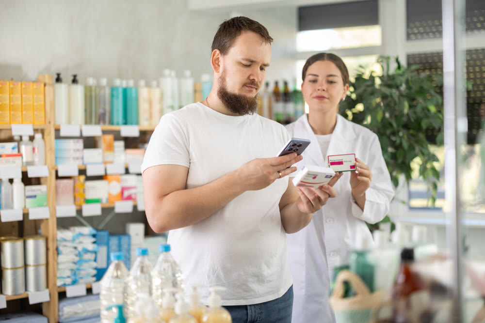 Man scans QR code on box paracetamol pills label. Female pharmacist offers to choose right shampoo