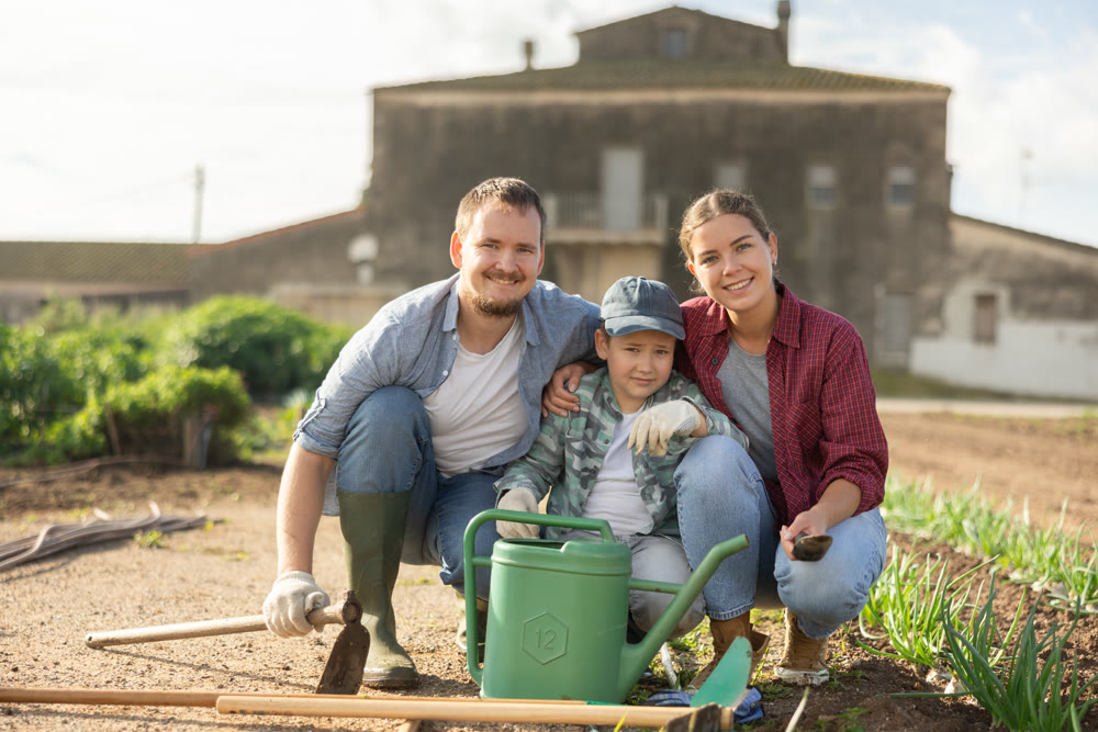 Family of farmers standing in the garden
