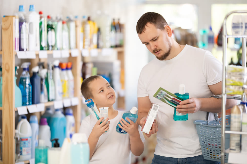 Man and boy choosing dental care products