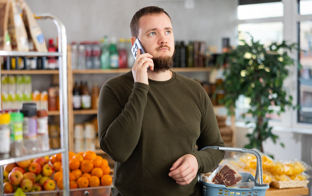 Man in the store calls on the phone.