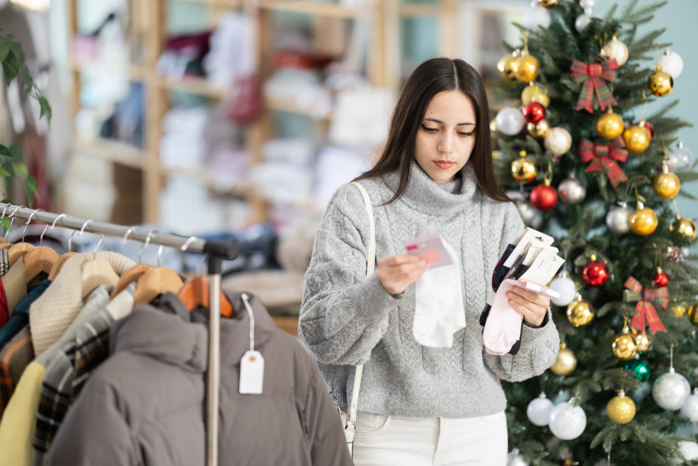 Young woman chooses socks in clothing store