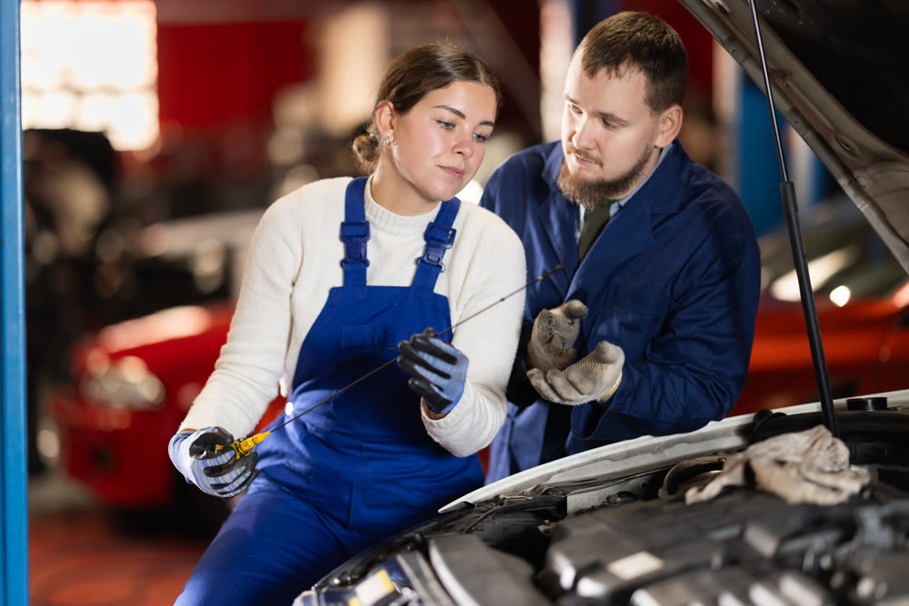 Mechanics check the oil