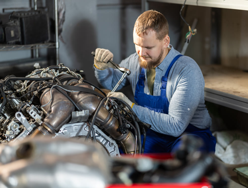 experienced mechanic repairs the engine