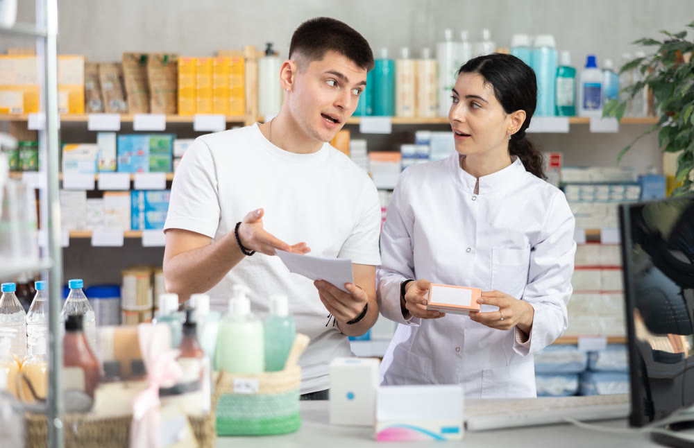 Man choosing prescription medications with help of pharmacist