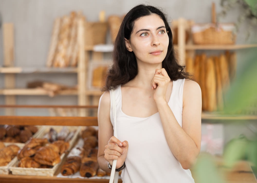 Young woman looking around in bakery