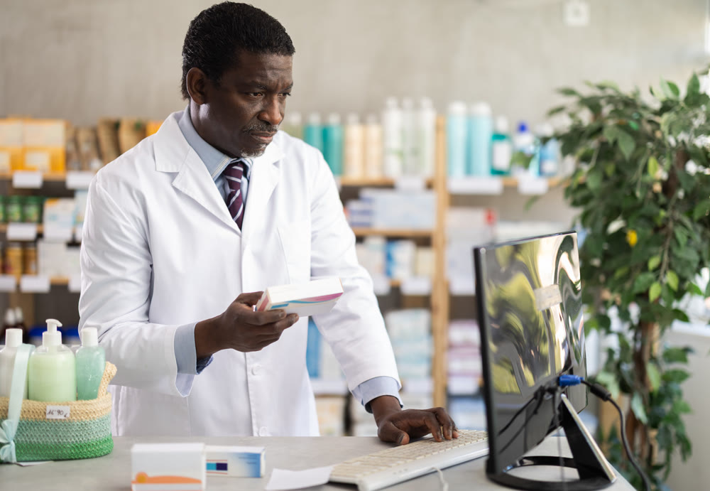 Experienced pharmacist searches for information about medicines on Internet