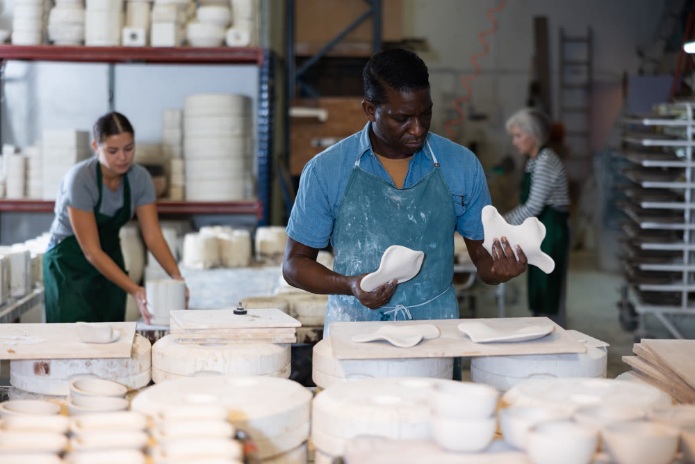 Man ceramist working in pottery workshop