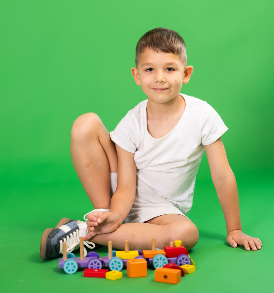Boy with toy wooden train