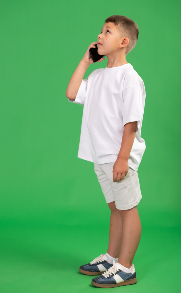 Preschooler boy is talking on phone