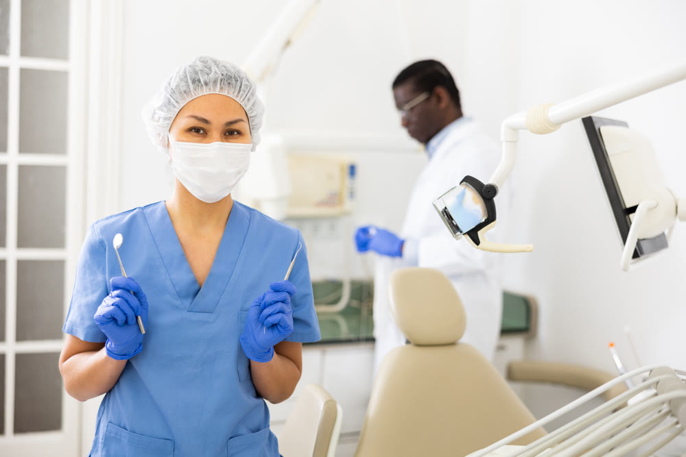 Portrait of woman chairside assistant wearing mask, in office of dental clinic