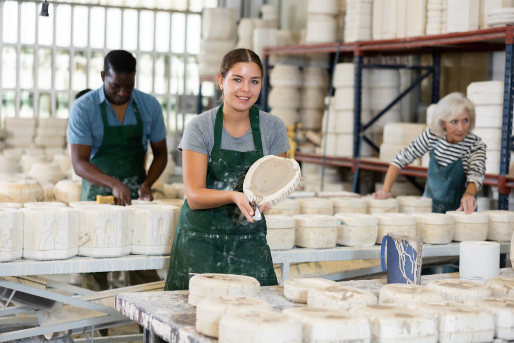 Positive woman potter with form for new ware
