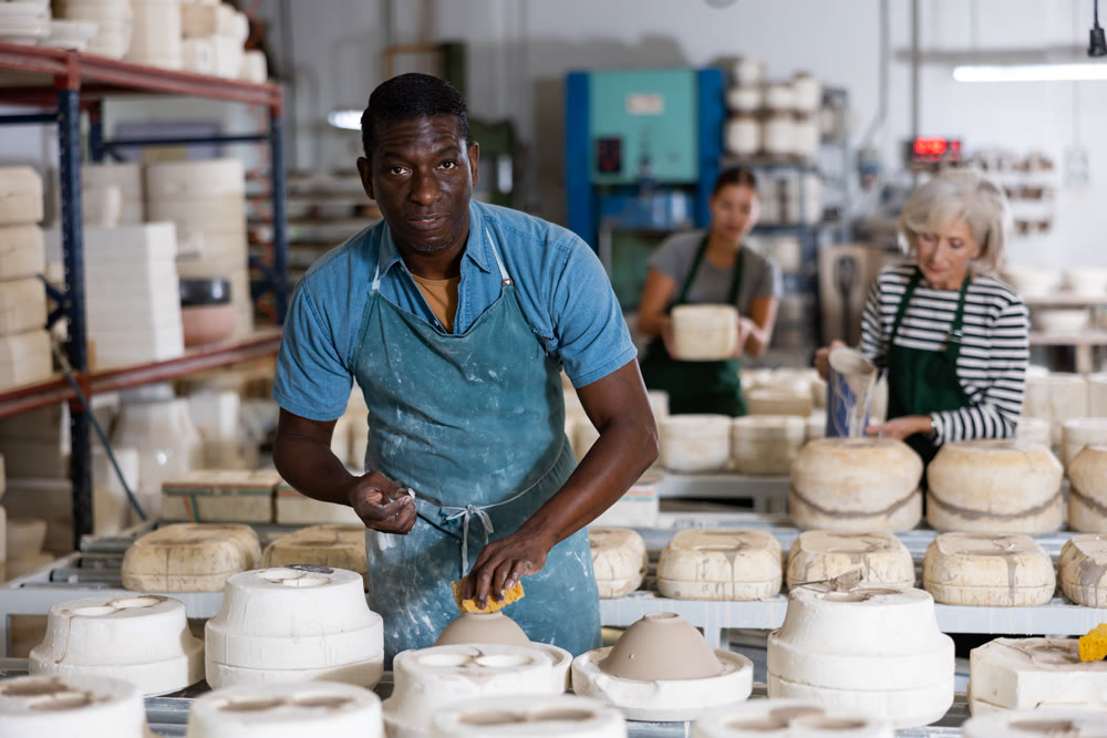 Ceramist polishing new clay plates