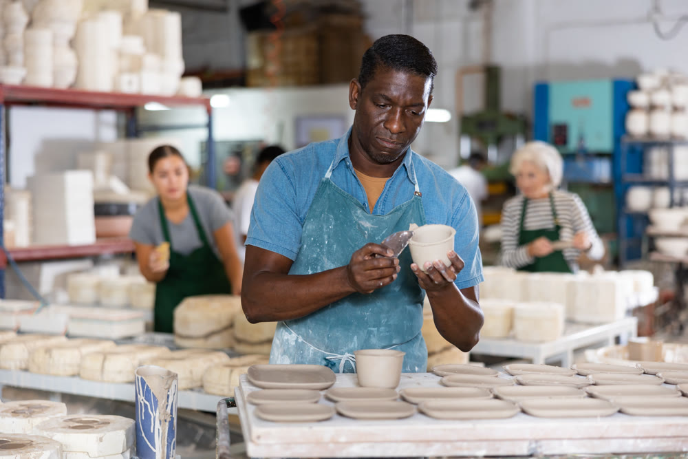 Ceramist processing new clay plates