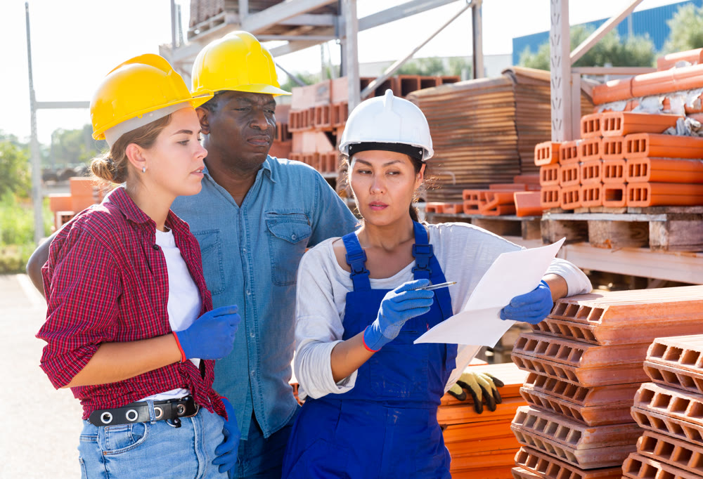Group of workers discussing order list at warehouse