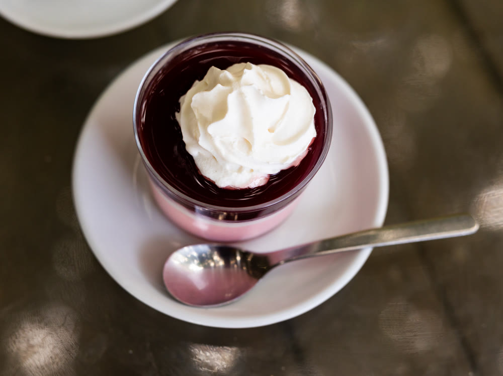 Yogurt with wild berries, raspberries and blueberries, decorated with whipped cream
