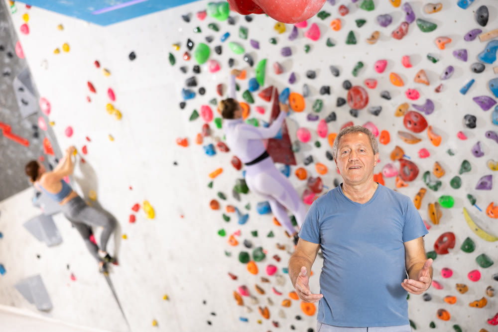 Adult man posing on climbing wall