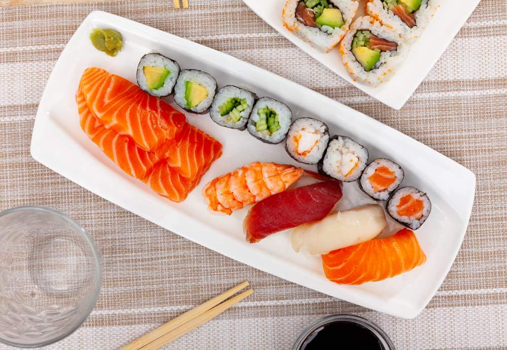 On table there portion set with maki, sashimi and nigiri