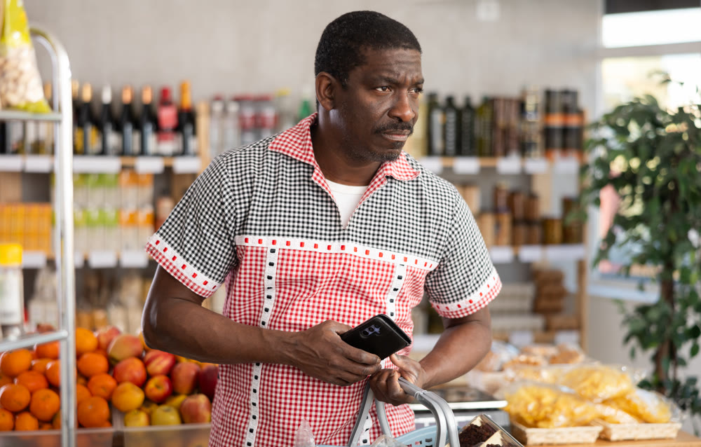 Adult man choosing food in grocery store