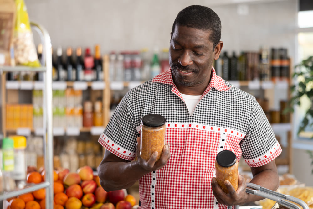 Adult man choosing lentils in grocery store