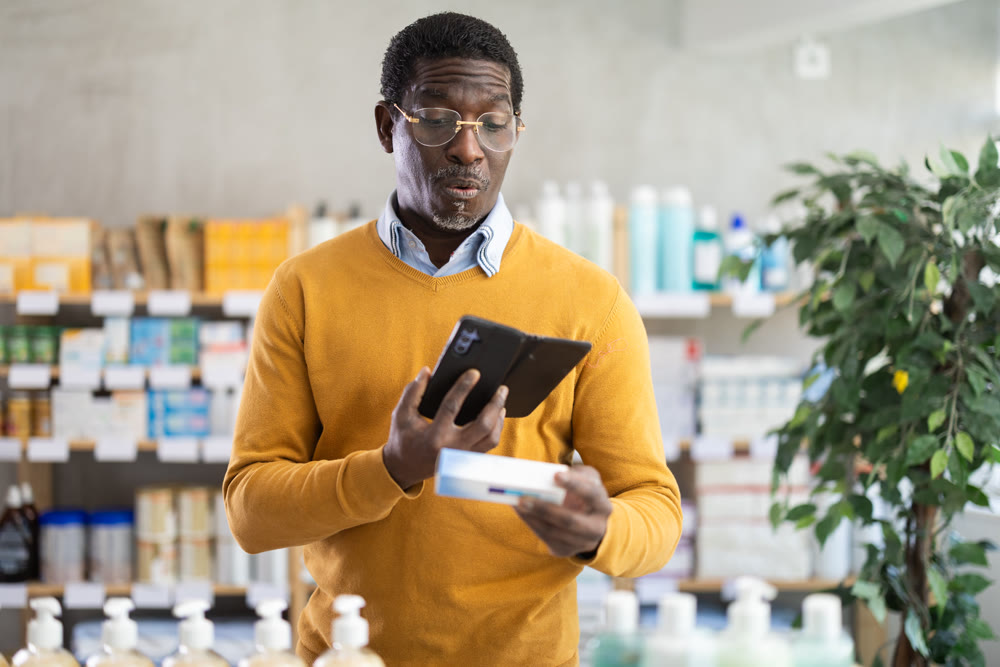 Adult man scanning qr code of ointment