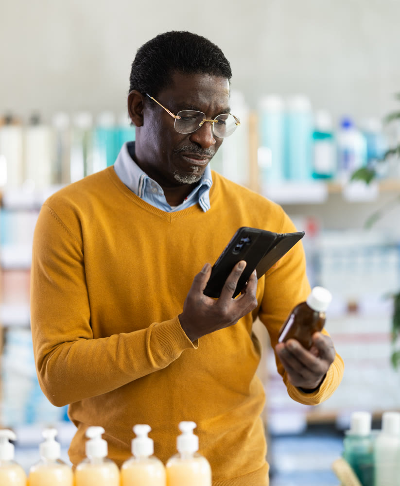 Adult man scanning qr code of syrup