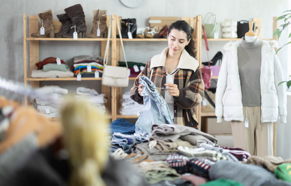 Armenian woman choosing jeans pants and pants in the store