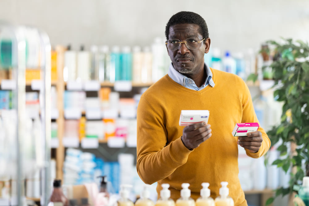 African man choose buy painkiller paracetamol tablet at pharmacy