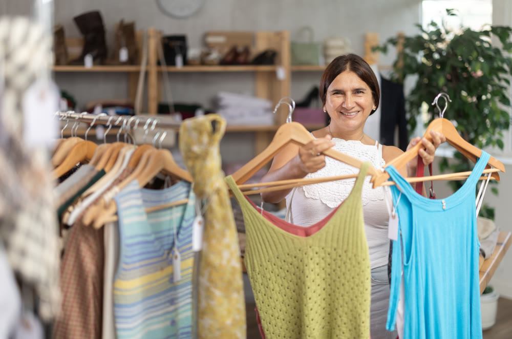 Latin woman customer turn over and choose something summer cloth in store,