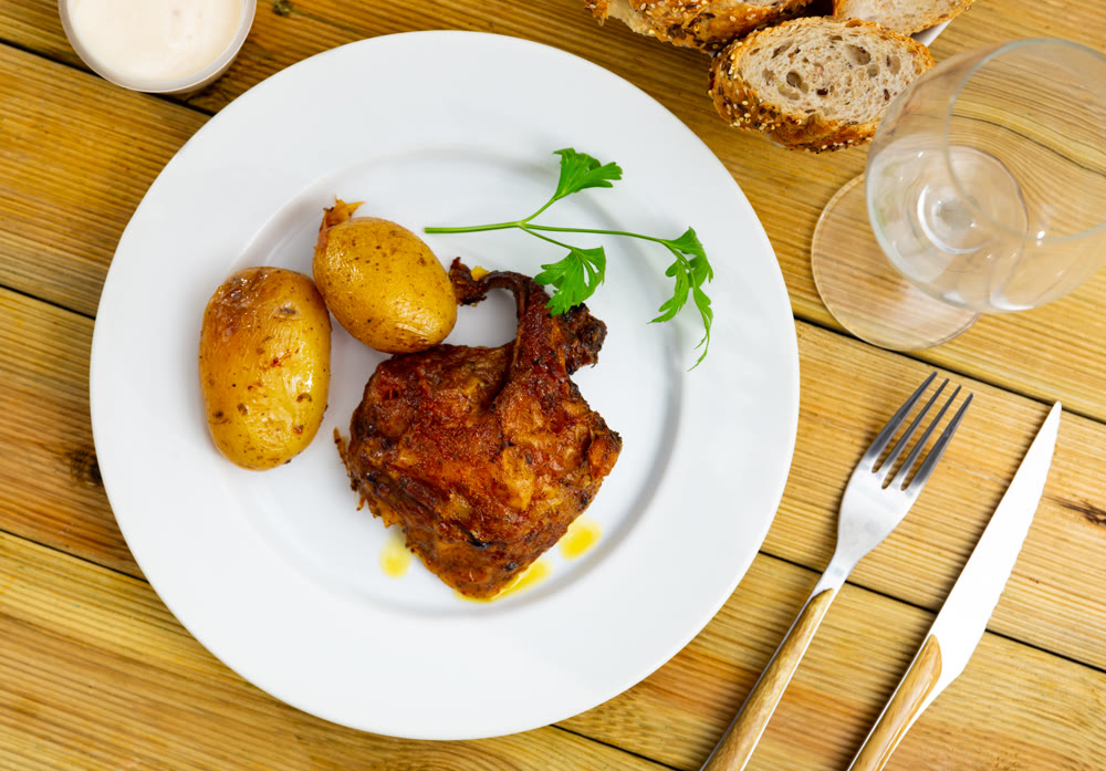 Tasty dish of chicken thighs and boiled potatoes