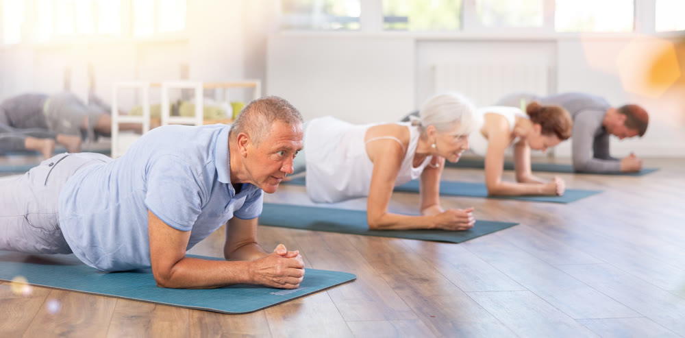 Elderly man doing pilates in group