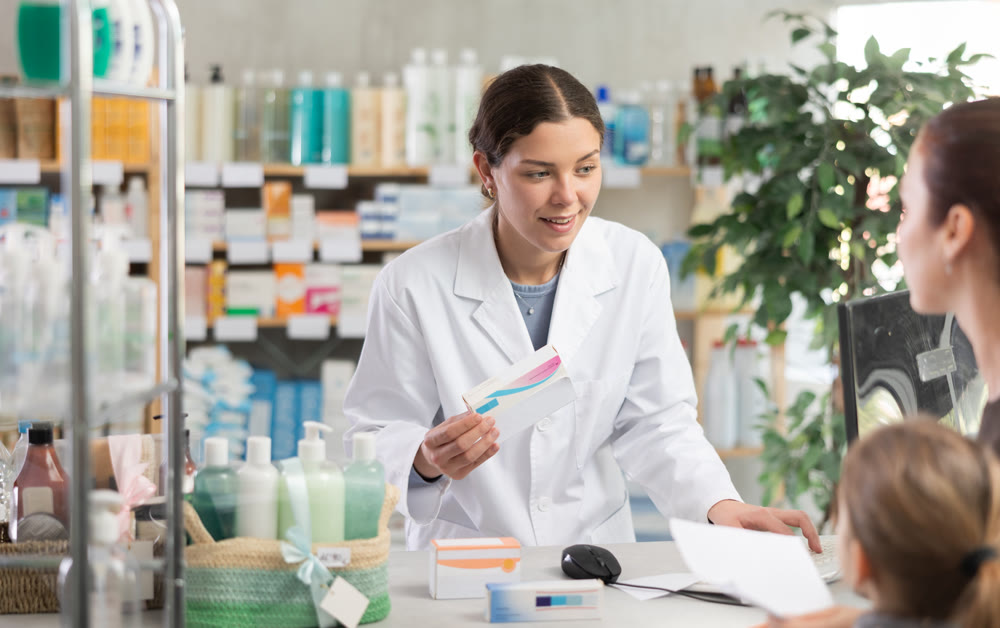 Woman pharmacist using computer during family consulting