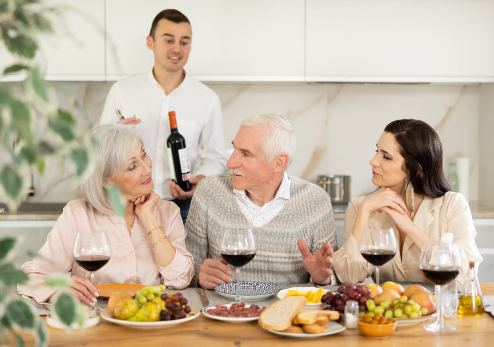 Elderly parents with daughter and son-in-law enjoying dinner