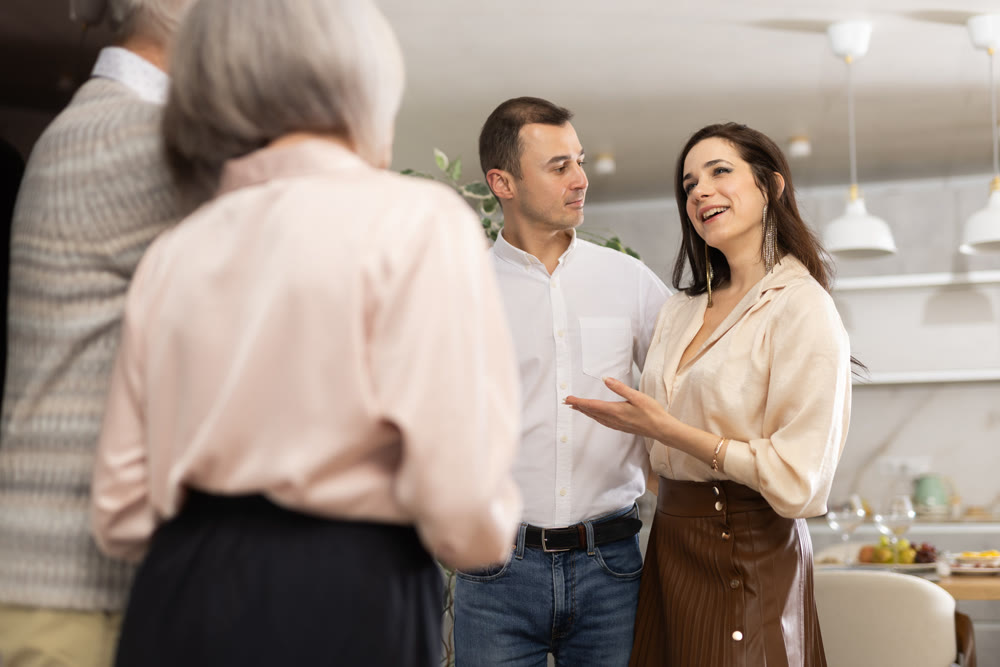Joyful woman introducing boyfriend to elderly parents at home