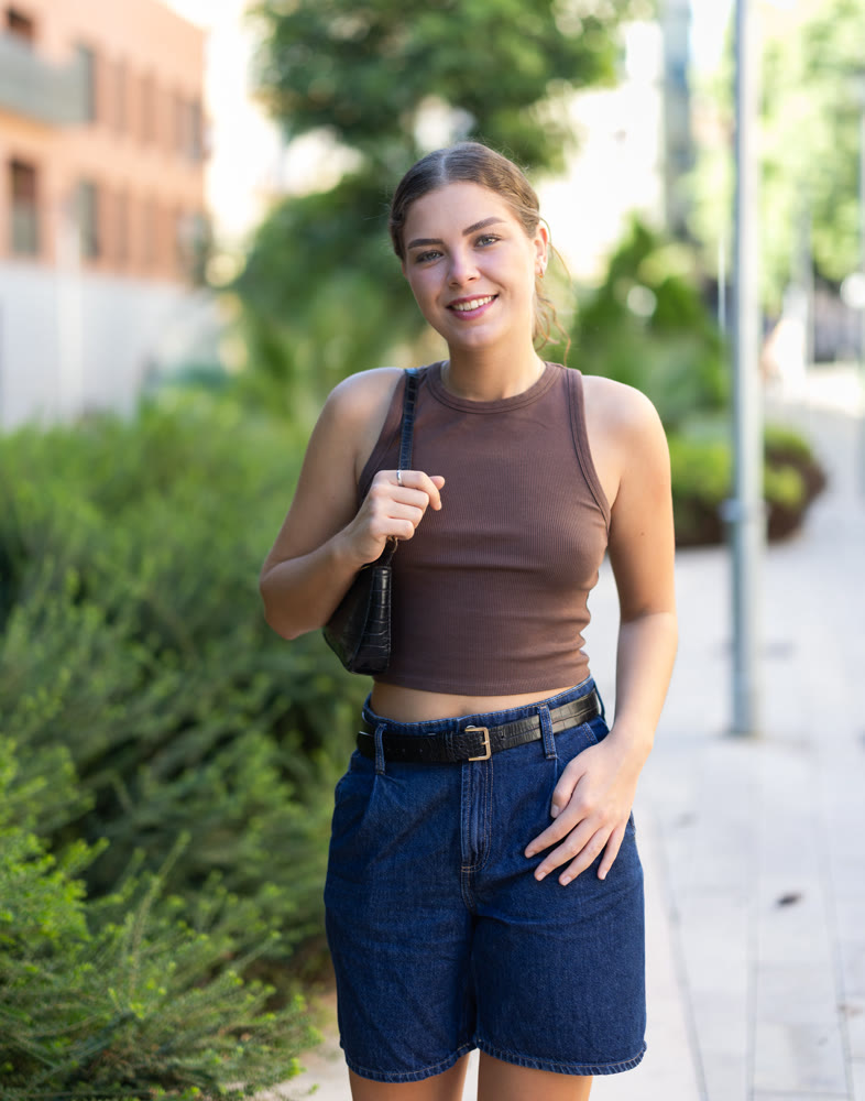 Young woman walks along city street