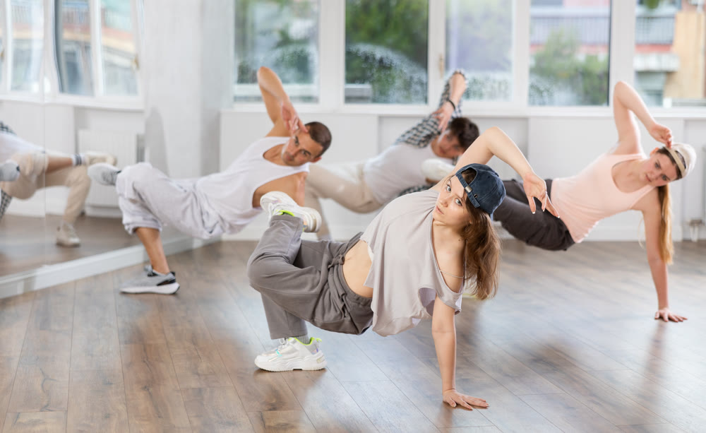 Young girl practicing breakdance in training hall