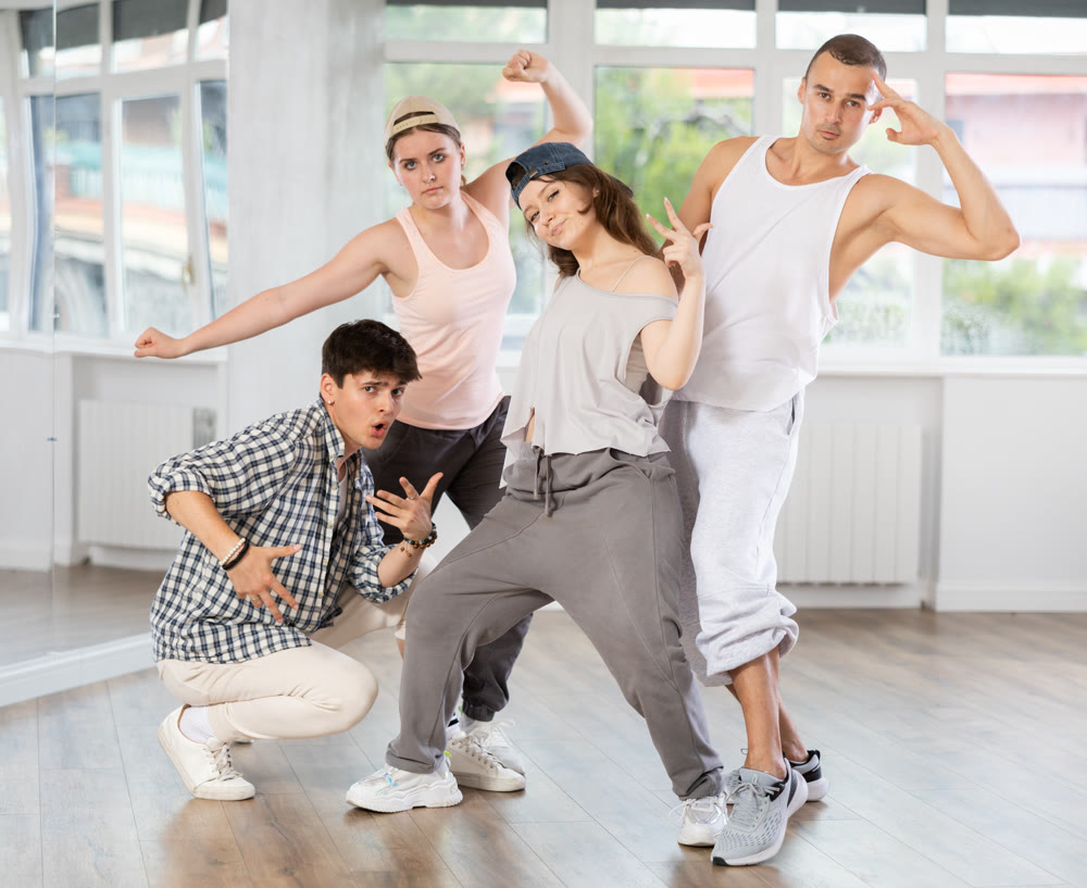 Group of young hip hop dancers posing in dance studio