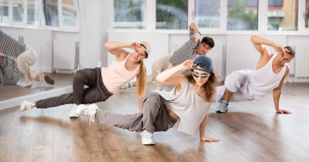 Young girl practicing breakdance floor-works in training hall