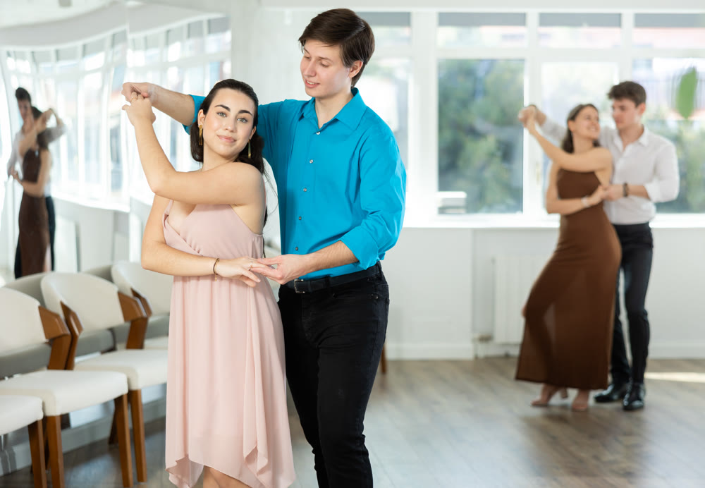 Couple young woman and man dancing waltz