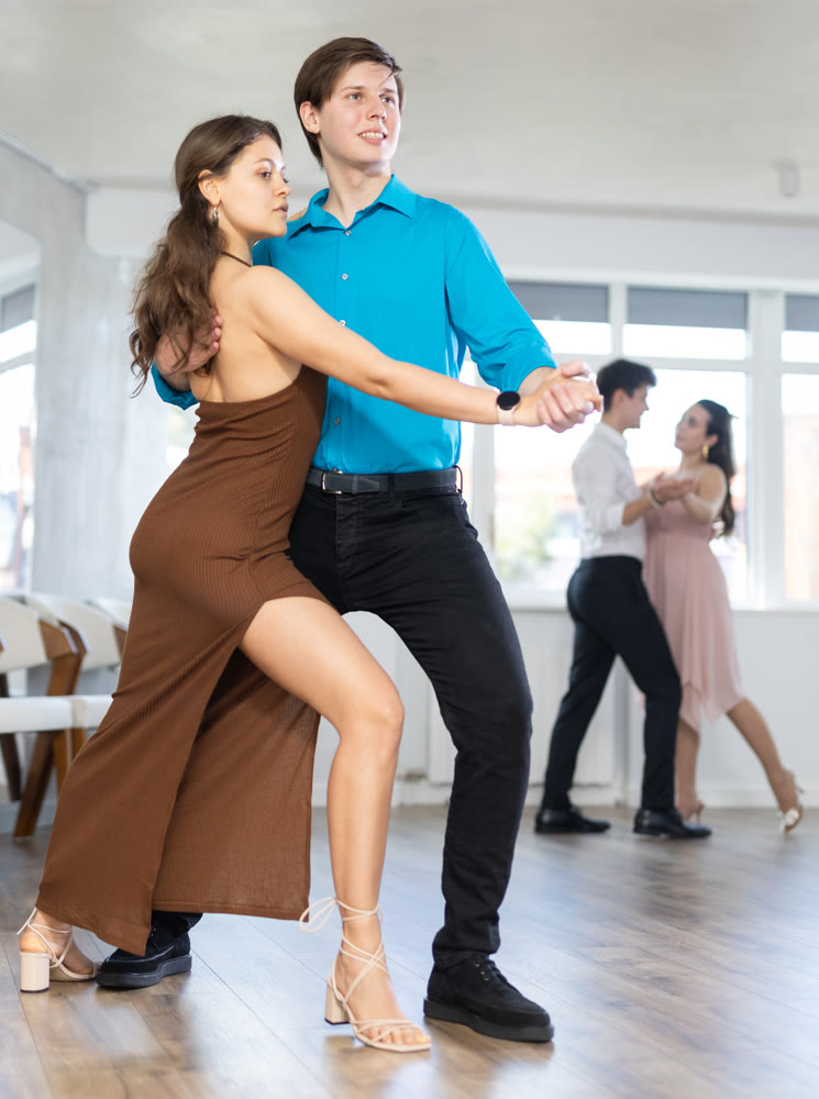 Couple young woman and man dancing latin dances