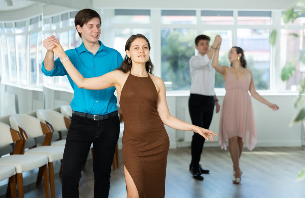 Couple young woman and man dancing waltz