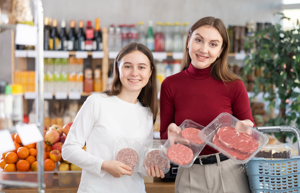 Mother and child choose cutlets and meat