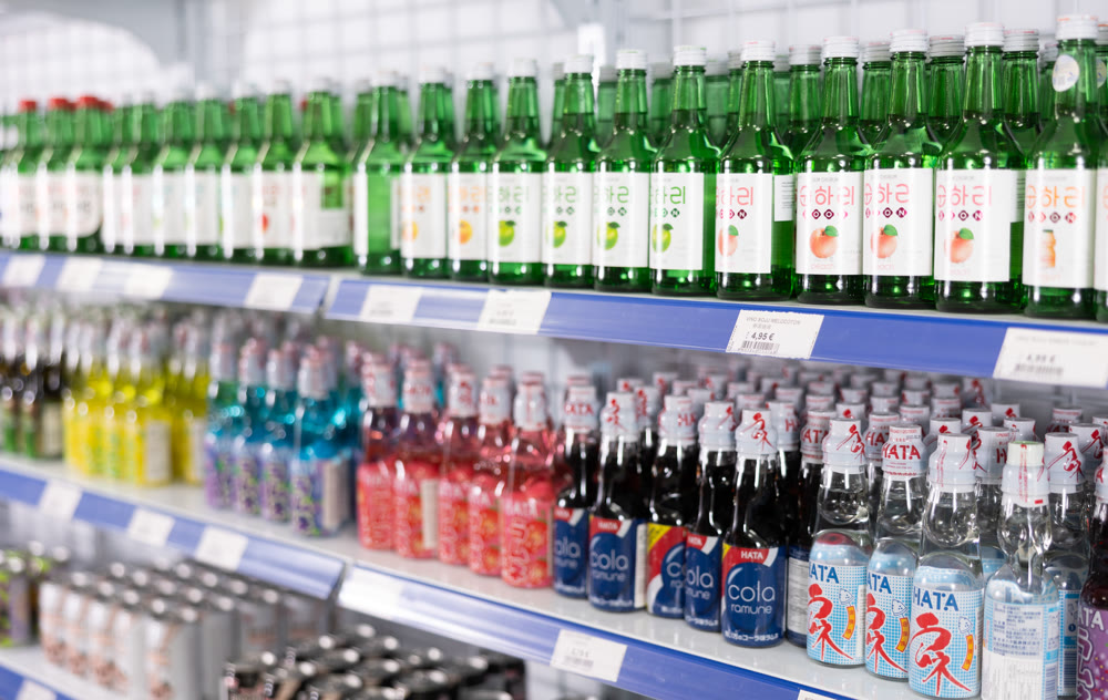 Reus, Spain - May 30, 2024: Bottles with various drinks on shelves in Chinese supermarket